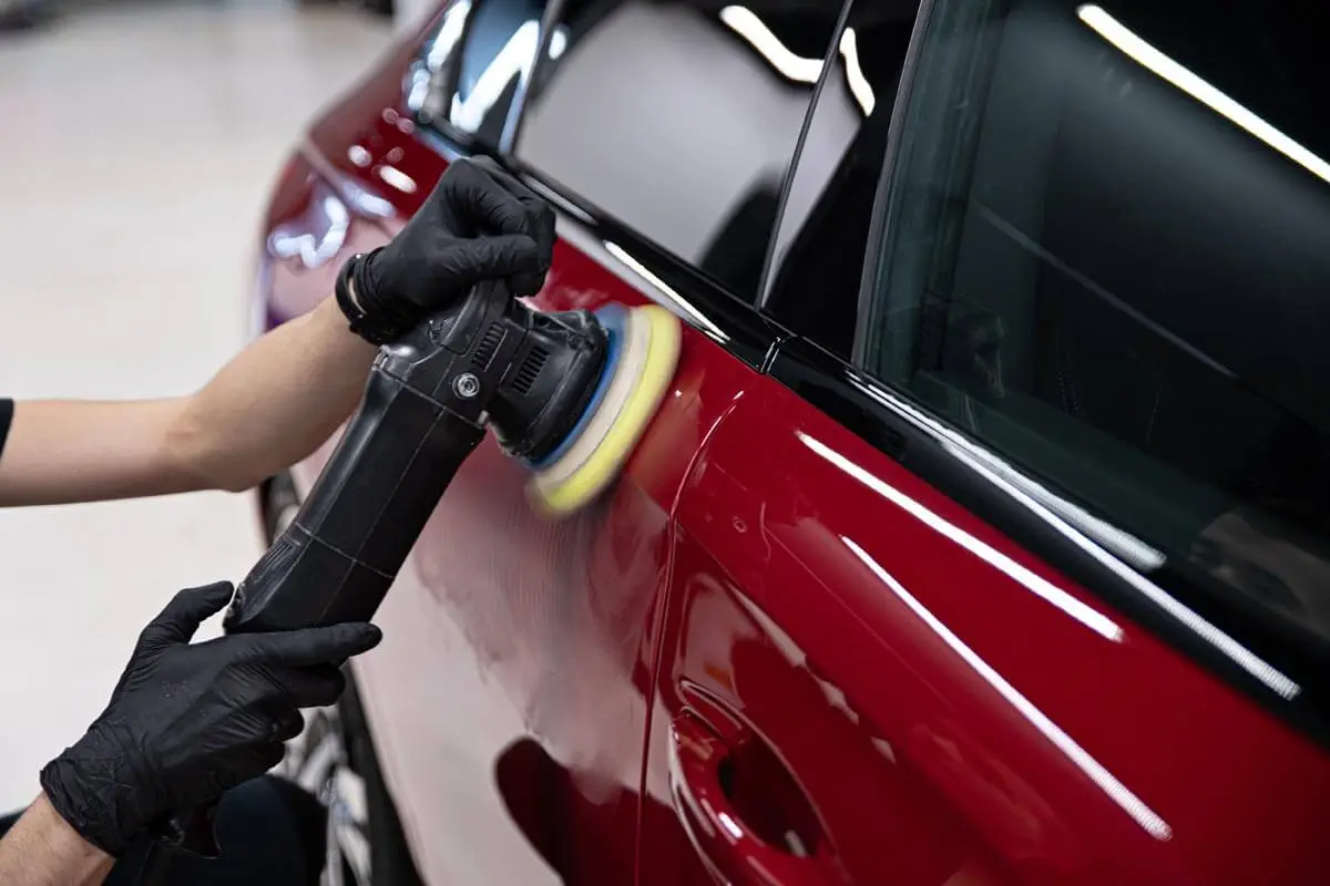 Detailer performing a paint correction service using a RUPES dual-action polisher.